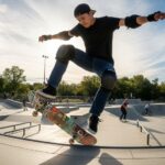 Adult wearing black knee pads and elbow pads while skateboarding at outdoor skate park