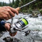 Close up of hand holding budget friendly spinning reel casting smoothly at sunset.